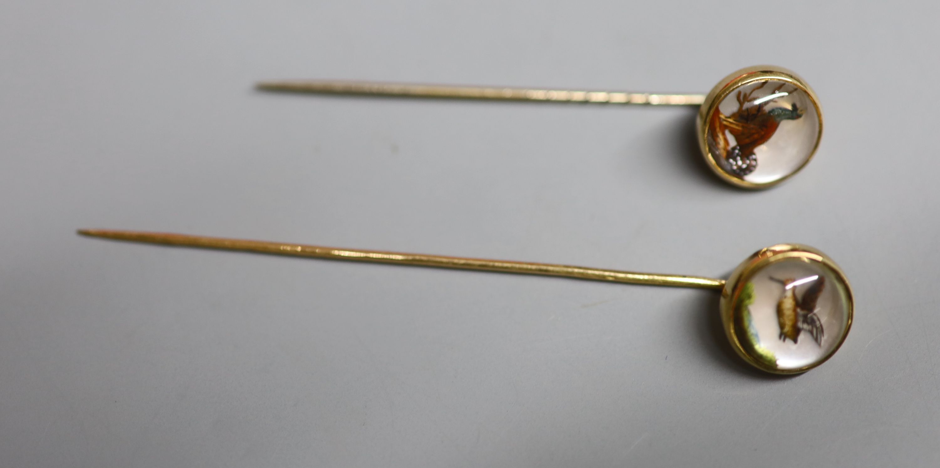Two yellow metal and Essex crystal stick pins, decorated with game birds, largest 72mm, gross 5.8 grams.